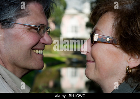 Mature adult couple couple smiling at each other, Benrath castle, Duesseldorf, state capital of NRW, North-Rhine-Westphalia, Ger Stock Photo