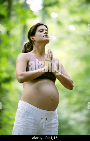 Pregnant woman meditating Stock Photo