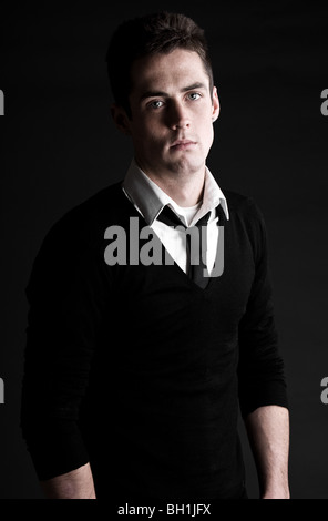 Low Key Shot of a Handsome Male in White Shirt and Black Tie Stock Photo