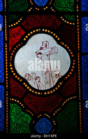 Crude unfinished stained glass window depicting the Crucifixion, St Michael's Church, Caerhays, Cornwall Stock Photo