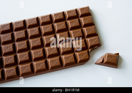 Large bar of Cadbury's chocolate with one piece broken off ! Stock Photo