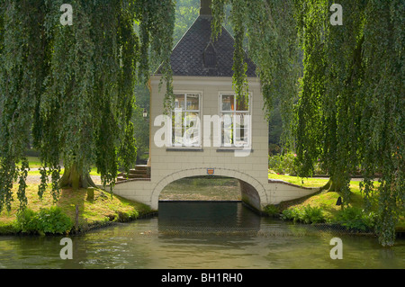 Hut on a bridge over Merwede canal under willows, Netherlands, Europe Stock Photo