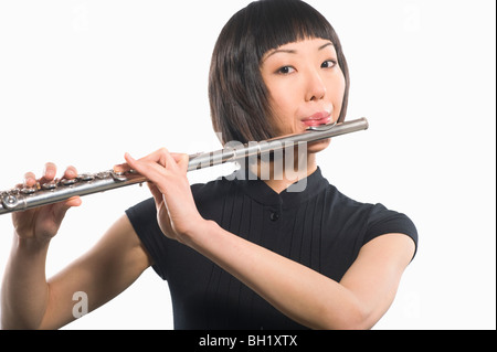 Young Korean woman playing flute Stock Photo