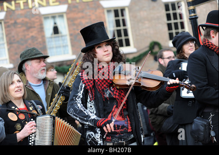 Female violinist with The Ironmen and Severn Gilders morris dancers performing on the Ironbridge on New Years Day Stock Photo