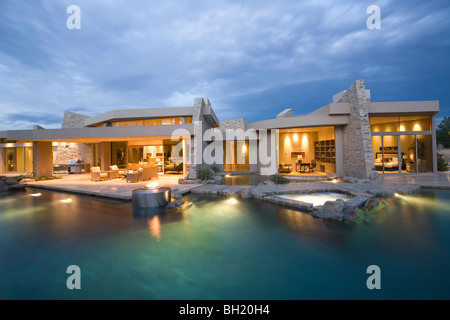 Palm Springs swimming pool and house exterior at dusk Stock Photo