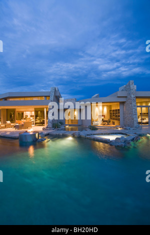 Palm Springs swimming pool and house exterior at dusk Stock Photo