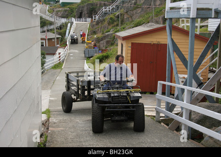 Concrete walkways constitute the only roads for golf cart size vehicles in the outport village of Francois, Newfoundland Stock Photo