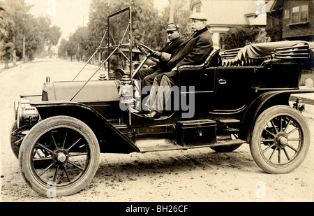 Two Old Men in Touring Car Parked Sideways Stock Photo