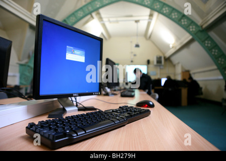 Computer monitor, keyboard and mouse with children in the background Stock Photo