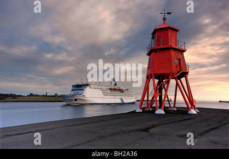 Groyne lighthouse with large boat going by in background Stock Photo