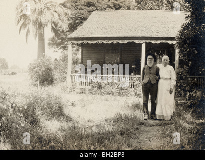 Aged Couple in front of California Bungalow Stock Photo