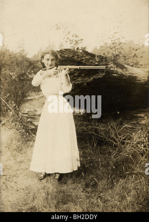 Young Woman Firing Repeater Rifle Stock Photo