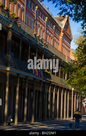 Man walking dog by Upper Pontalba Building French Quarter New Orleans, Louisiana Stock Photo