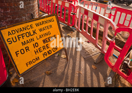 A sign warning of roadworks due to laying a new water main in the Uk Stock Photo