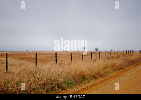 Farm scenes of rural America with rustic barns, charming homes, trailers, corrals, fence lines and roads on the lonesome prairie Stock Photo