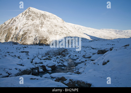 Ogwen Valley Conwy North Wales January Mountain stream Pen Yr Ole Wen in the Carneddau Mountain range on a snowy winters day Snowdonia Nationl Park Stock Photo