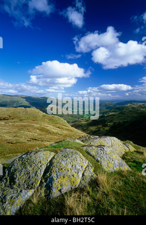 A view in summer in the Lake District National Park looking towards Helm Crag and Grasmere Village from Grasmere Common Stock Photo