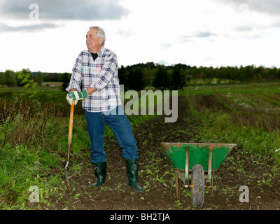 Mature man with shovel Stock Photo