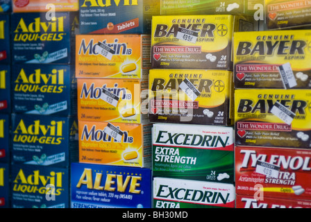 A collection of over the counter pain relievers in the window of a bodega in the Washington Heights neighborhood of New York Stock Photo