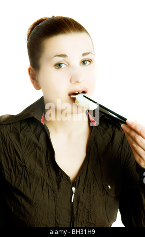 women bites into a sushi roll Stock Photo