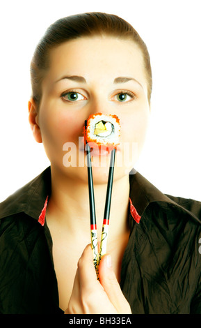 women bites into a sushi roll Stock Photo