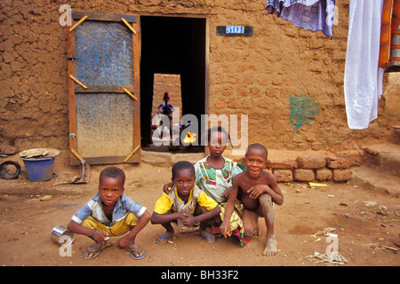 CHILDREN IN THE COURTYARD OF THEIR HOUSE, LOCAL DWELLING, BOBO-DIOULASSO, BURKINA FASO Stock Photo