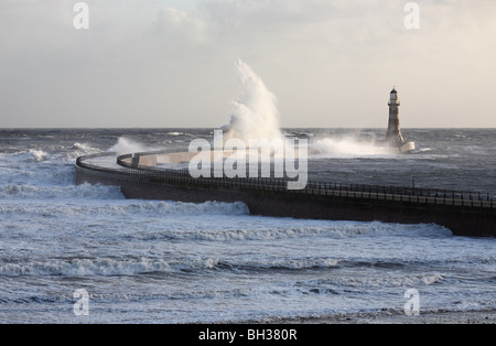 Strong easterly winds cause large breaking waves over the pier at Roker, Sunderland, UK Stock Photo