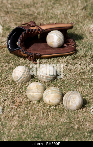 White Cricket balls and a Baseball Glove. Picture by James Boardman Stock Photo