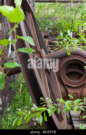 Mining equipment Quincy Mine Hancock Upper Peninsula Michigan MI in USA US a rusty wheel in foreground close up pictures images vertical hi-res Stock Photo