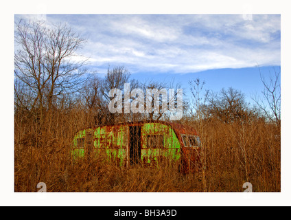 Farm scenes of rural America with rustic barns, charming homes, trailers, corrals, fence lines and roads on the lonesome prairie Stock Photo