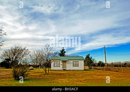 Farm scenes of rural America with rustic barns, charming homes, trailers, corrals, fence lines and roads on the lonesome prairie Stock Photo