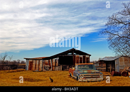 Farm scenes of rural America with rustic barns, charming homes, trailers, corrals, fence lines and roads on the lonesome prairie Stock Photo