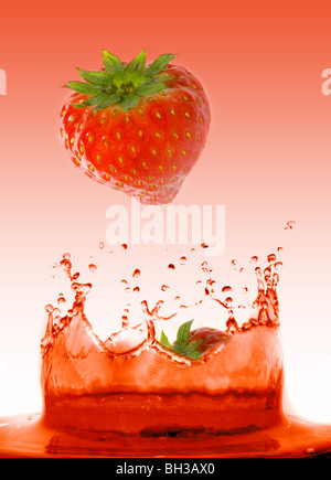 Strawberry falling in juice. Isolation. Stock Photo