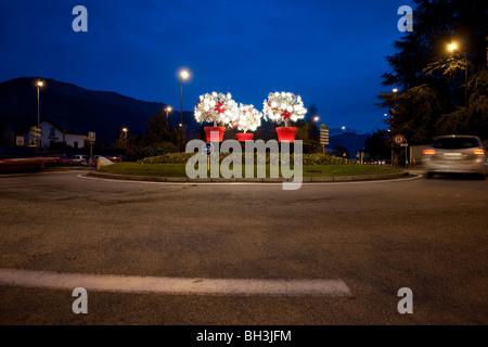 Roundabout decorated for Christmas in Annecy, France, photographed during early evening. Stock Photo