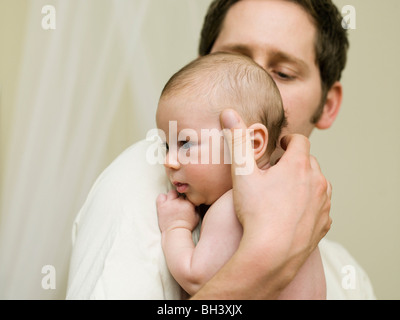 A father holding his new born baby Stock Photo