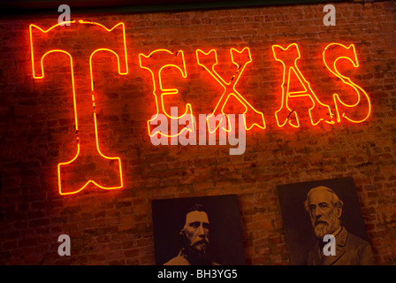 Interior wall with neon sign 'Texas' and photographs of General John Bell Hood and General Robert E. Lee in Jefferson, Texas Stock Photo