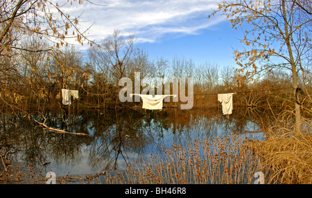 Farm scenes of rural America with rustic barns, charming homes, trailers, corrals, fence lines and roads on the lonesome prairie Stock Photo
