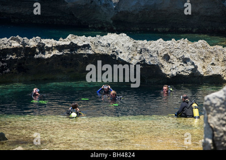 Scuba divers at blue hole by Azure Window at Dwejra Point. Stock Photo