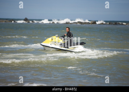 Man riding on jet ski at Norfolk Coast. Stock Photo