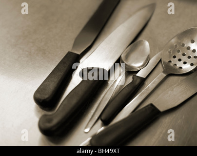 Kitchen implements on a steel table Stock Photo