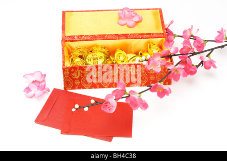 Chinese new year gift box, red packets and ornaments on white background Stock Photo