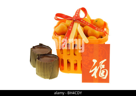 Gift basket of mandarin oranges and Chinese new year rice cakes on white background Stock Photo