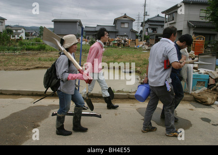 Residents of Sanjo city, clean up after a week of torrential rains forced breaks in the banks of Igarashi River, Japan. Stock Photo