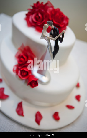 Wedding cake with bride and groom on top Stock Photo