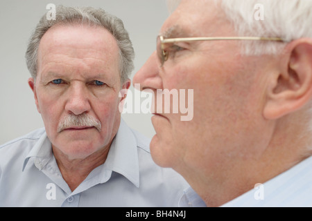 Close up portrait of two senior men with serious expressions Stock Photo