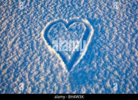 a love heart drawn in the snow Stock Photo