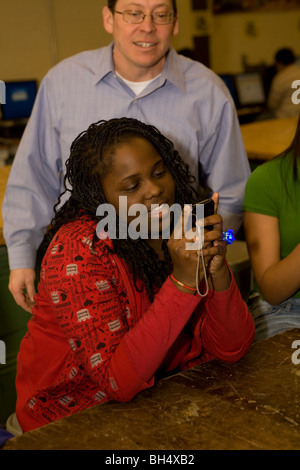 Middle school technology class works with cell phones, ipods and hand held devices as well as computers in Freeport, New York Stock Photo