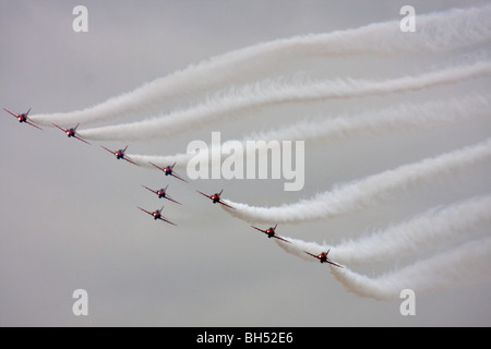 The famous Red Arrows display team flying in formation over Bournemouth Bay in August. Stock Photo