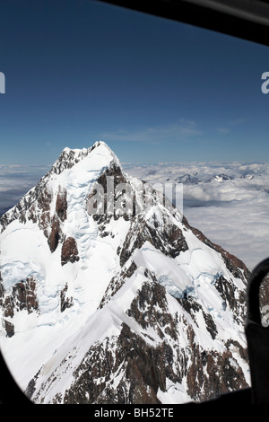 Views of Mts Cook and Tasmin through the window of a helicopter in summer. Stock Photo