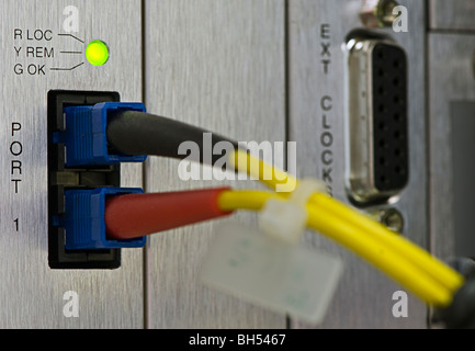 Fiber cables connected to servers in a datacenter Stock Photo
